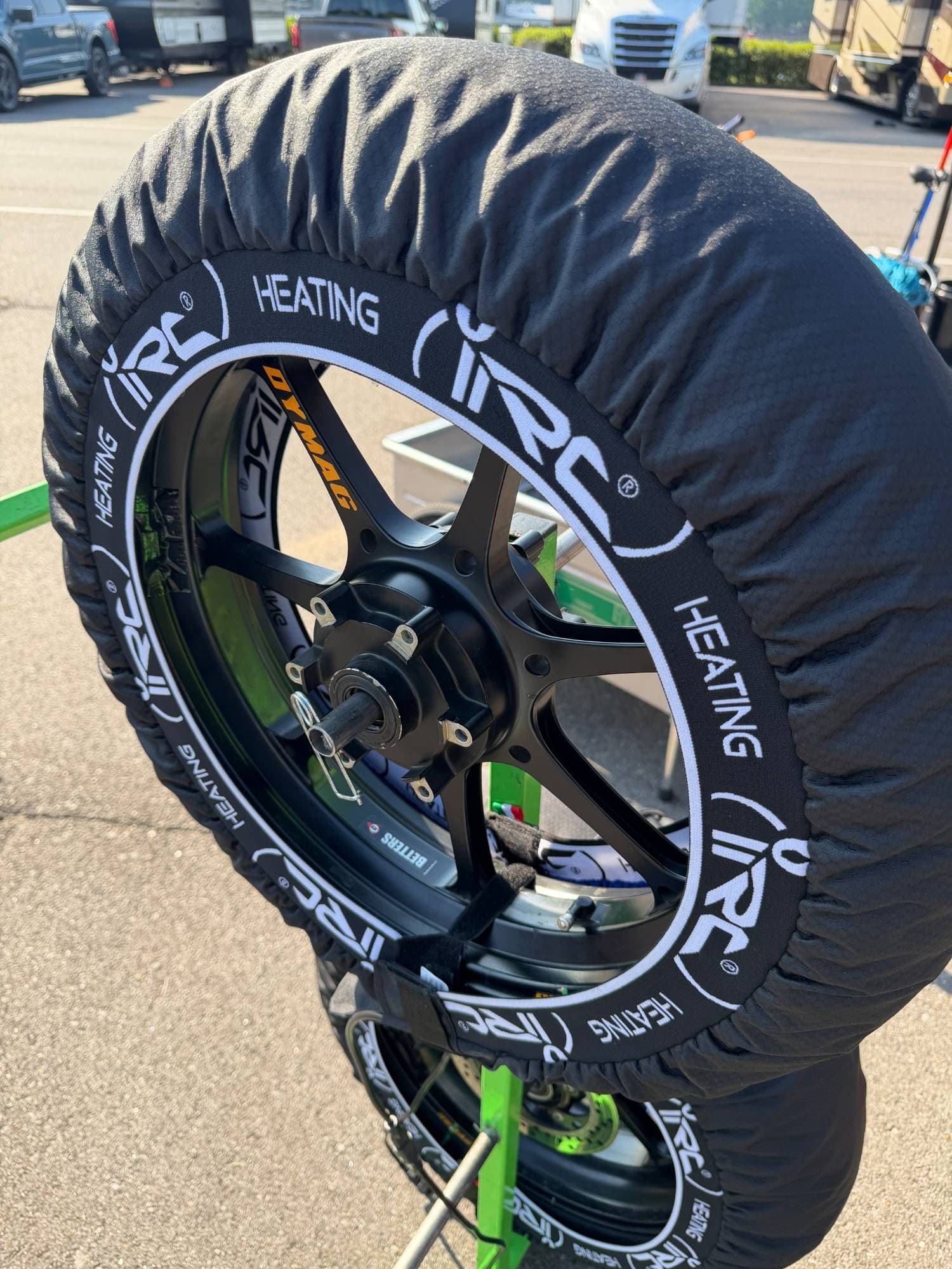 IRC Components tire warmer with HEATING branding on a Dymag wheel